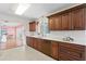 Beautiful kitchen featuring custom cabinets, a tiled backsplash, and sleek appliances at 2171 E Vina Del Mar Blvd, St Pete Beach, FL 33706