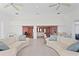 Open concept living room with hardwood floors and glass doors providing water views at 2171 E Vina Del Mar Blvd, St Pete Beach, FL 33706