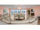 Open concept living room with hardwood floors and glass doors providing water views at 2171 E Vina Del Mar Blvd, St Pete Beach, FL 33706