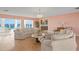 Spacious living room with water views, comfortable seating, and an open layout to the kitchen at 2171 E Vina Del Mar Blvd, St Pete Beach, FL 33706