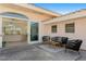 Inviting outdoor patio with stylish furniture set on tile near the opening to an indoor living area at 2171 E Vina Del Mar Blvd, St Pete Beach, FL 33706