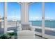 Cozy sitting area with large glass doors offering stunning water views at 2171 E Vina Del Mar Blvd, St Pete Beach, FL 33706