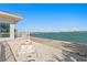 Waterfront exterior featuring a small boat, decorative tiling, and views of a bridge and the water at 2171 E Vina Del Mar Blvd, St Pete Beach, FL 33706