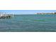 Scenic view of the waterfront featuring a dock and a distant bridge at 2171 E Vina Del Mar Blvd, St Pete Beach, FL 33706