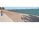 Waterfront patio area with a unique patterned walkway by the seawall and boat dock at 2171 E Vina Del Mar Blvd, St Pete Beach, FL 33706