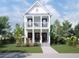 Charming two-story home featuring double balconies, black doors, and professional landscaping at 2308 N 13Th St, Tampa, FL 33605