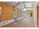 Unfinished sunroom featuring plywood walls, white ceiling, a wall of windows, and door to outside at 2320 Coffee Pot Ne Blvd, St Petersburg, FL 33704