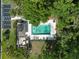 Aerial view showcasing a pristine community pool, ample seating, and visitor parking at 25 Woods Landing Trl, Oldsmar, FL 34677