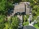 Aerial view of the property showing the roofline, landscaping, and driveway at 25 Woods Landing Trl, Oldsmar, FL 34677