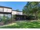 Grassy backyard with screened-in patio and lush landscaping, perfect for outdoor enjoyment at 25 Woods Landing Trl, Oldsmar, FL 34677