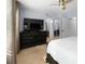 Well-lit bedroom showing dresser, closet, and windows with backyard view at 25 Woods Landing Trl, Oldsmar, FL 34677
