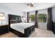 Comfortable primary bedroom with a ceiling fan and ample natural light at 25 Woods Landing Trl, Oldsmar, FL 34677