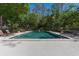 Community pool featuring clear water, lounge chairs, and shaded areas for relaxation at 25 Woods Landing Trl, Oldsmar, FL 34677