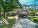 Attractive townhouse complex featuring carports and mature trees, offering a blend of convenience and natural beauty at 25 Woods Landing Trl, Oldsmar, FL 34677