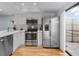 Bright kitchen featuring stainless steel appliances, white cabinets, and access to a patio perfect for outdoor dining at 25 Woods Landing Trl, Oldsmar, FL 34677
