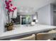 Close-up of kitchen island, white countertops, tile backsplash, and modern faucet offering a stylish and functional space at 25 Woods Landing Trl, Oldsmar, FL 34677