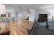 Open living area with hardwood floors, leading to the kitchen and staircase at 25 Woods Landing Trl, Oldsmar, FL 34677