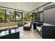 Enclosed patio with cozy wicker furniture and natural light, perfect for enjoying the outdoors at 25 Woods Landing Trl, Oldsmar, FL 34677