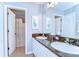 Well-lit bathroom featuring a double sink vanity with granite countertops and a separate shower area at 2515 Cross More St, Valrico, FL 33594