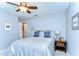Inviting bedroom with a ceiling fan, a bedside table, and soft, natural lighting at 2515 Cross More St, Valrico, FL 33594