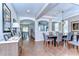 A spacious dining room with modern lighting, hardwood floors, and a view of the living spaces at 2515 Cross More St, Valrico, FL 33594