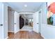 Inviting entryway showcasing hardwood floors and an open view into a room with built-in bookshelves at 2515 Cross More St, Valrico, FL 33594
