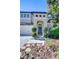 View of the front door with gray paint, flanked by topiaries and leading to a walkway at 2515 Cross More St, Valrico, FL 33594