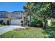 Charming home exterior showcasing a well-manicured lawn, a two car garage, and beautiful landscaping at 2515 Cross More St, Valrico, FL 33594