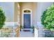 Welcoming front porch with stone accents and a stylish front door framed by lush greenery at 2515 Cross More St, Valrico, FL 33594