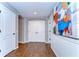 Hallway with hardwood floors, picture frame molding and wall art at 2515 Cross More St, Valrico, FL 33594