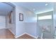Hallway with hardwood floors, picture frame molding, and wall art at 2515 Cross More St, Valrico, FL 33594