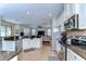 Open kitchen view with stainless steel appliances and granite countertops overlooking the living room at 2515 Cross More St, Valrico, FL 33594