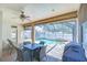 Covered lanai with outdoor dining area overlooking a screened-in pool and spa at 2515 Cross More St, Valrico, FL 33594