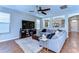 Comfortable living room with a large sectional sofa, media center and wood floors at 2515 Cross More St, Valrico, FL 33594