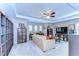 Spacious living room with custom bookshelves, comfortable seating, and a decorative ceiling fan at 2515 Cross More St, Valrico, FL 33594