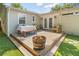 Cozy backyard wooden deck with table, chairs, string lights, and lush artificial turf at 2751 36Th N Ave, St Petersburg, FL 33713
