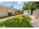 Backyard featuring artificial turf, stone pathway, and storage shed at 2751 36Th N Ave, St Petersburg, FL 33713