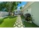 Backyard view with artificial turf, patio, shed, grill, and pavers at 2751 36Th N Ave, St Petersburg, FL 33713