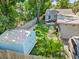 Aerial backyard view with artificial turf, patio, storage shed, and privacy fence at 2751 36Th N Ave, St Petersburg, FL 33713