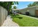 Turfed backyard with wooden fence, stone, patio, and grill at 2751 36Th N Ave, St Petersburg, FL 33713