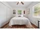 Cozy bedroom featuring natural light, hardwood floors, ceiling fan, and comfortable bedding at 2751 36Th N Ave, St Petersburg, FL 33713