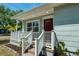 Inviting front entrance with a covered porch, decorative door, and well-manicured landscaping at 2751 36Th N Ave, St Petersburg, FL 33713