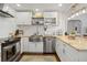 Bright kitchen with stainless steel appliances, white cabinets, and a farmhouse sink at 2751 36Th N Ave, St Petersburg, FL 33713