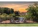 Backyard fire pit and deck overlooking the water at sunset at 3106 Whispering S Dr, Largo, FL 33771