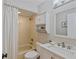 Bathroom featuring a shower/tub, updated vanity, built-in shelving for storage, and a neutral color palette at 3106 Whispering S Dr, Largo, FL 33771