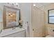 Bright bathroom featuring updated vanity, large mirror, and shower with a neutral color scheme at 3106 Whispering S Dr, Largo, FL 33771