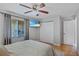 Bedroom featuring a ceiling fan, ample closet space, and a mounted TV for entertainment at 3106 Whispering S Dr, Largo, FL 33771