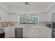 Bright, updated kitchen with stainless steel appliances and modern countertops at 3106 Whispering S Dr, Largo, FL 33771
