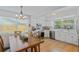 Bright, updated kitchen with stainless steel appliances and a wooden dining table at 3106 Whispering S Dr, Largo, FL 33771