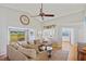 Bright living room featuring a large sectional sofa and view into kitchen at 3106 Whispering S Dr, Largo, FL 33771